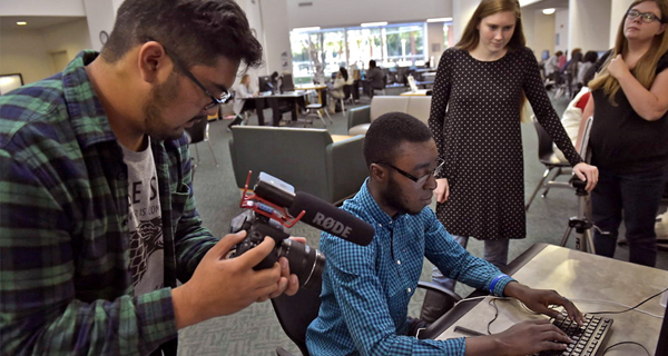 Students using a camera for an assignment.
